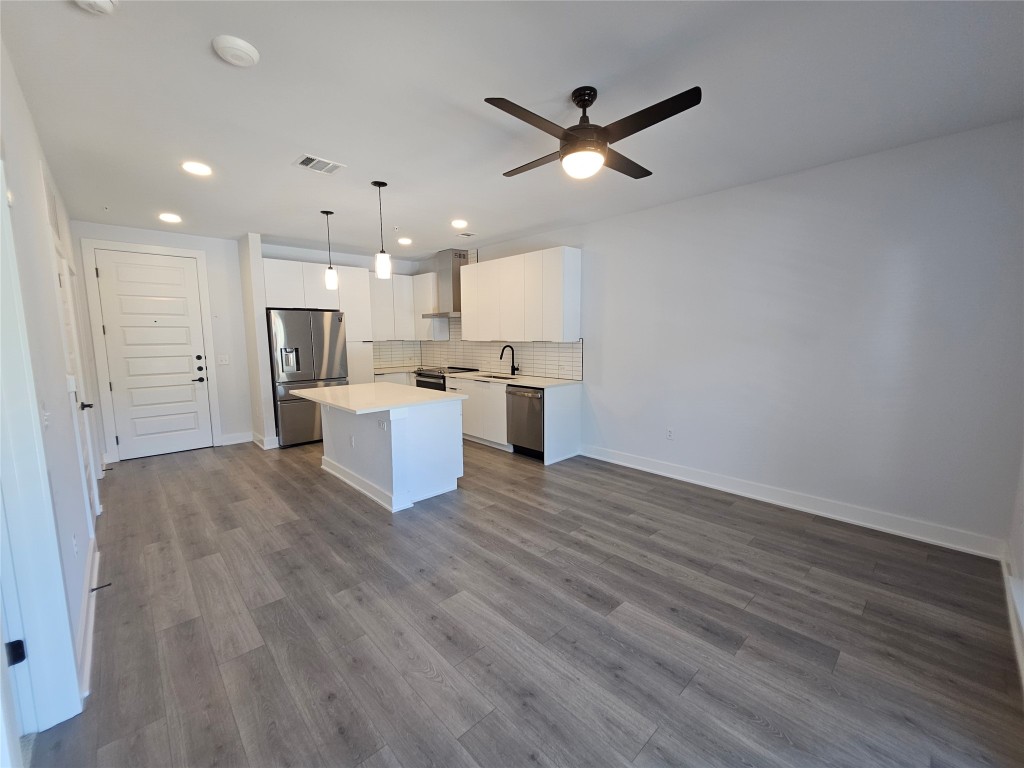 2220 Webberville Road, Unit 310 Austin, TX 78702 - Photo 11 of 39 a view of a kitchen with a refrigerator and a stove top oven