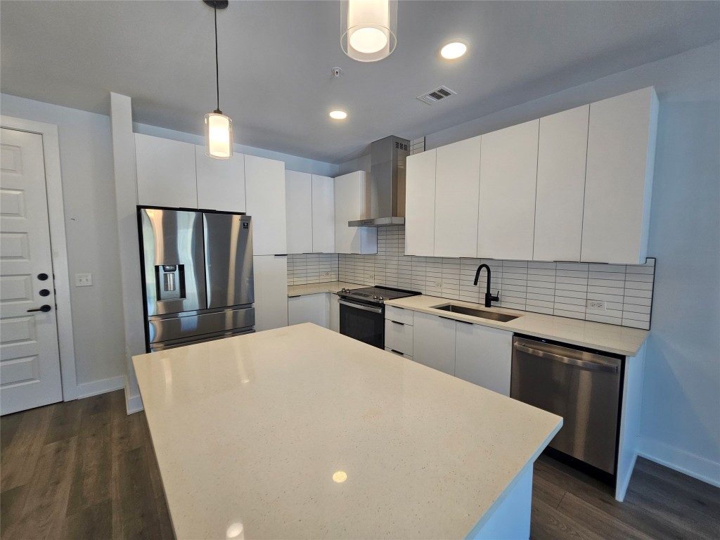 2220 Webberville Road, Unit 310 Austin, TX 78702 - Photo 12 of 39 a kitchen with stainless steel appliances a refrigerator sink and stove