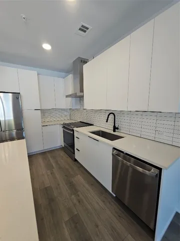 a kitchen with sink and cabinets