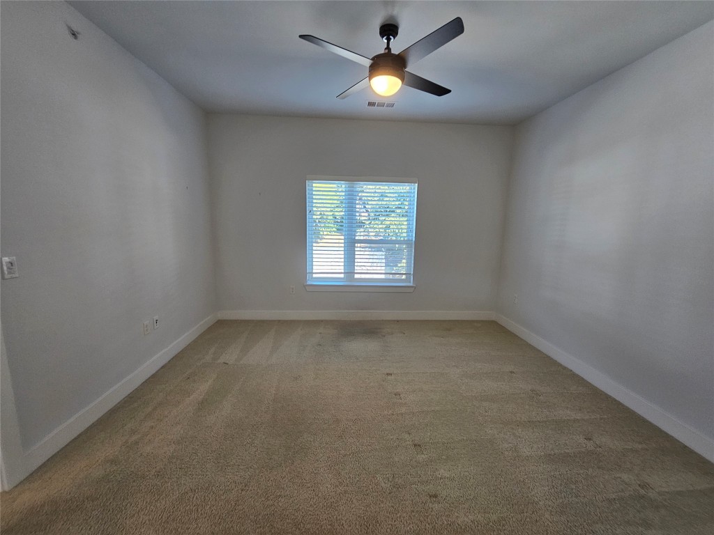 2220 Webberville Road, Unit 310 Austin, TX 78702 - Photo 20 of 39 an empty room with a window and a fan