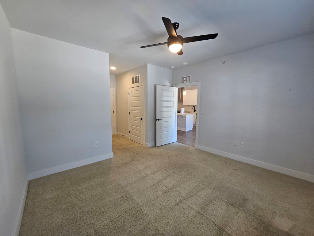 2220 Webberville Road, Unit 310 Austin, TX 78702 - Photo 21 of 39 an empty room with closet and fan
