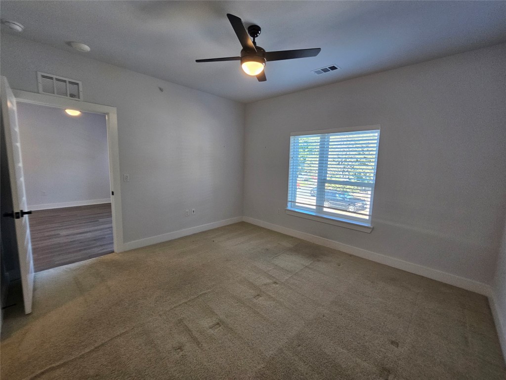2220 Webberville Road, Unit 310 Austin, TX 78702 - Photo 22 of 39 wooden floor in an empty room with a window
