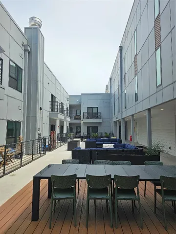 a view of a patio with chairs and potted plants
