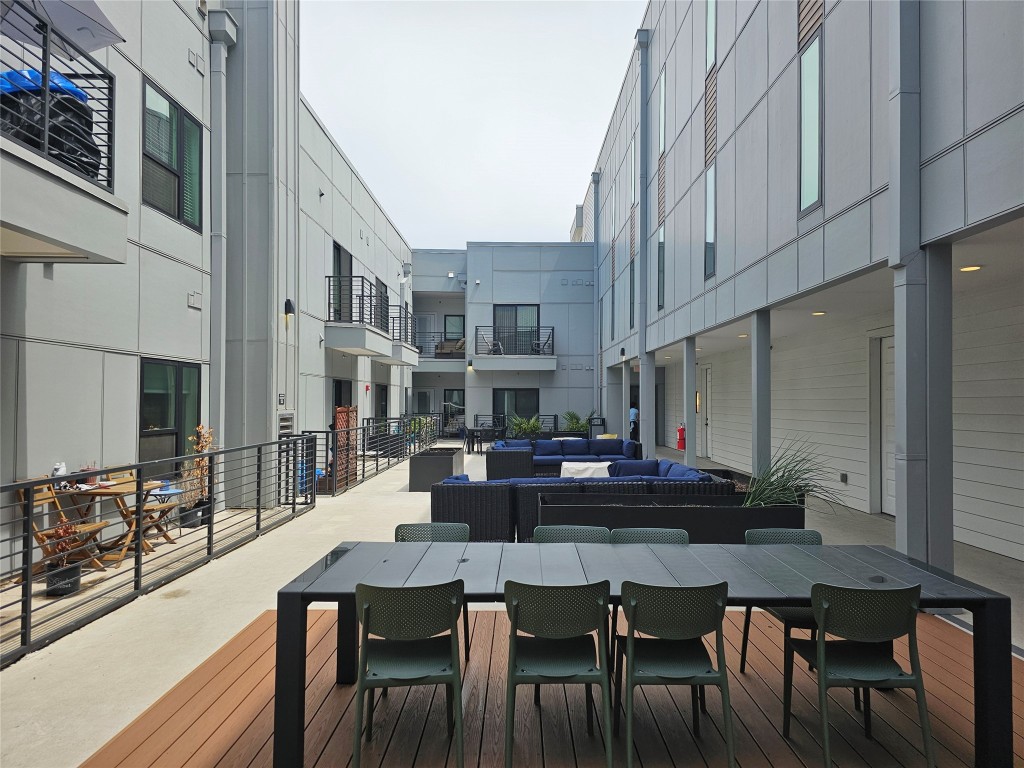 2220 Webberville Road, Unit 310 Austin, TX 78702 - Photo 36 of 39 a living room with stainless steel appliances furniture a dining table and a flat screen tv