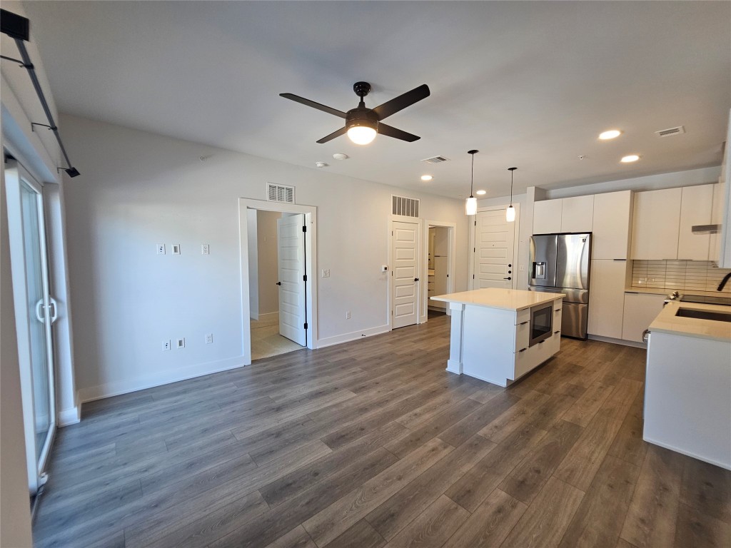 2220 Webberville Road, Unit 310 Austin, TX 78702 - Photo 9 of 39 a view of kitchen with cabinets microwave and stove