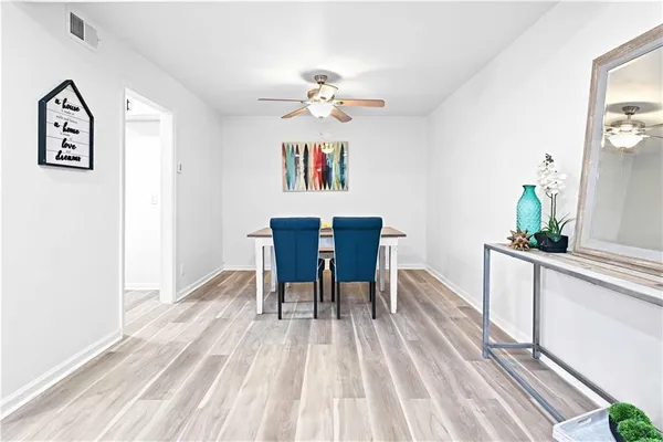 a view of a dining room with furniture and wooden floor