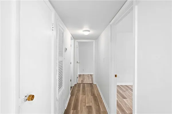 a view of hallway with wooden floor