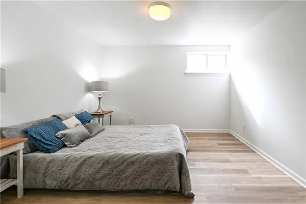 a bedroom with a bed and a lamp