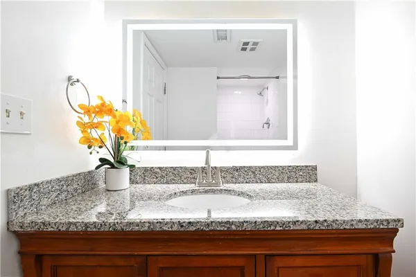 a bathroom with a sink and vanity