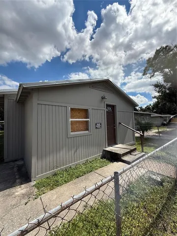 a backyard of a house with table and chairs