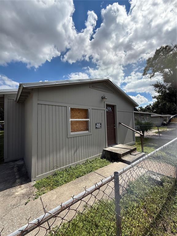 a backyard of a house with table and chairs