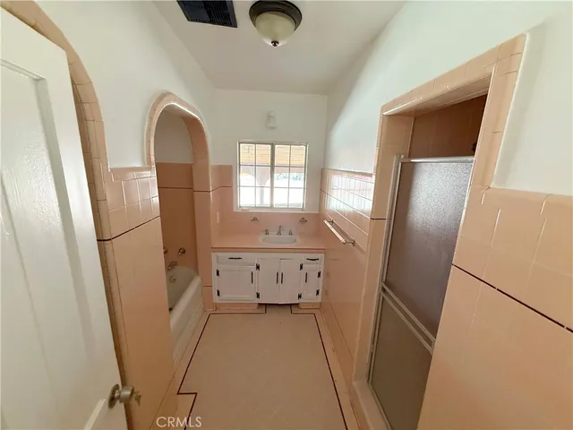 a view of kitchen with refrigerator and wooden floor