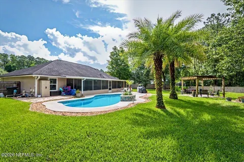 a view of a house with backyard sitting area and garden