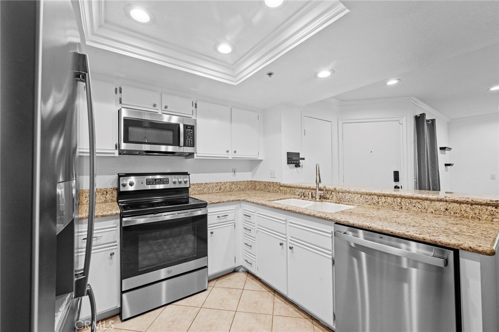 215 South Cross Creek Road, Unit L Orange, CA 92869 - Photo 10 of 50 a kitchen with a sink stove and microwave