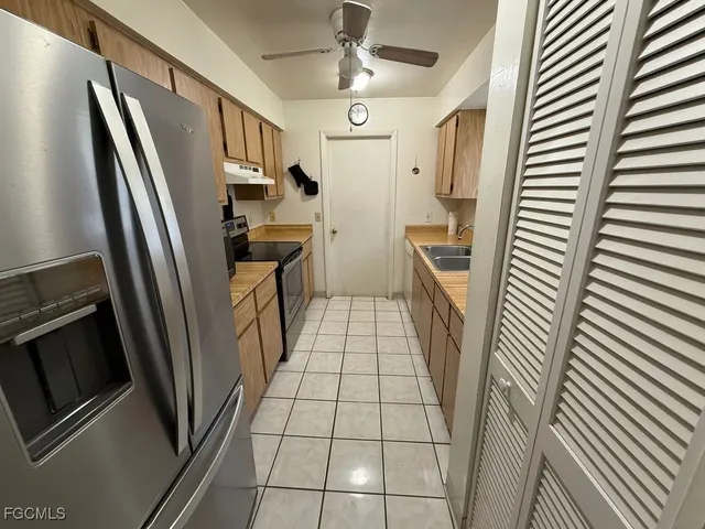 a kitchen with stainless steel appliances a refrigerator and a stove