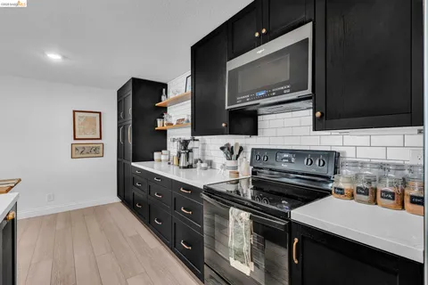 a kitchen with a stove and a microwave