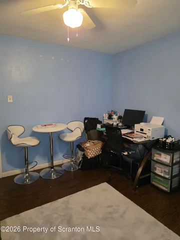 a living room with furniture a rug and a lamp