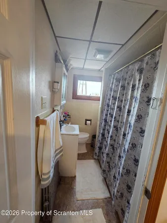 a bathroom with a toilet a sink and a shower