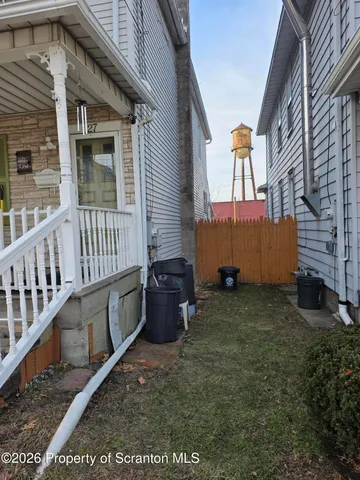 a backyard of a house with wooden fence and deck