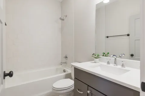 a bathroom with a sink a toilet and bathtub