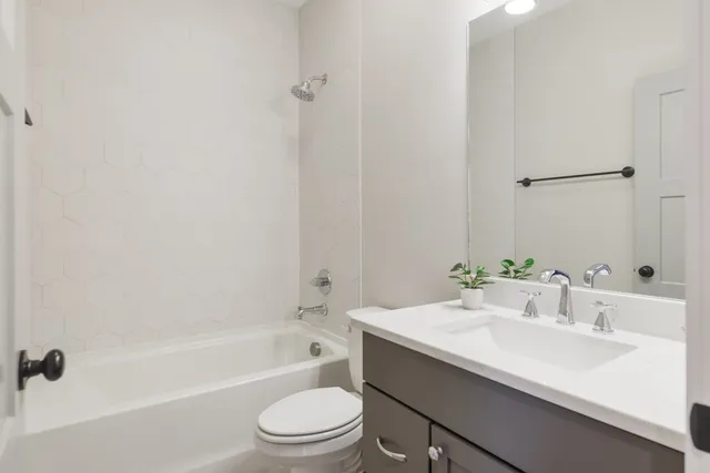 a bathroom with a sink a toilet and bathtub