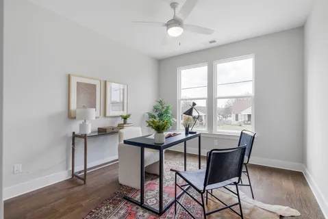 a dining room with furniture a chandelier and wooden floor