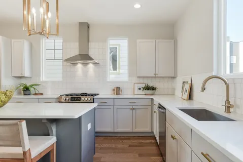 a kitchen with a sink stove and cabinets
