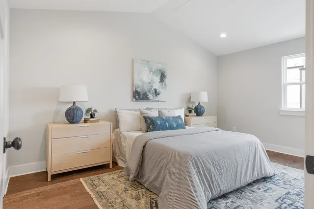 a bedroom with a bed and a painting on the wall