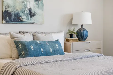 a bedroom with a bed and a lamp