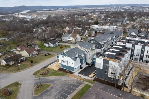 an aerial view of a house with a mountain