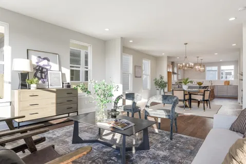 a living room with furniture a dining table and a piano table