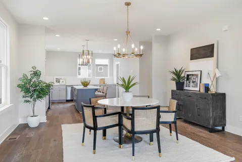 a view of a dining room with furniture and chandelier