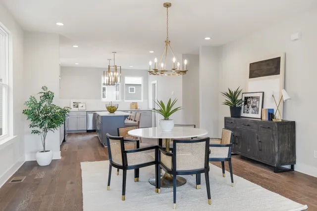 a view of a dining room with furniture and chandelier