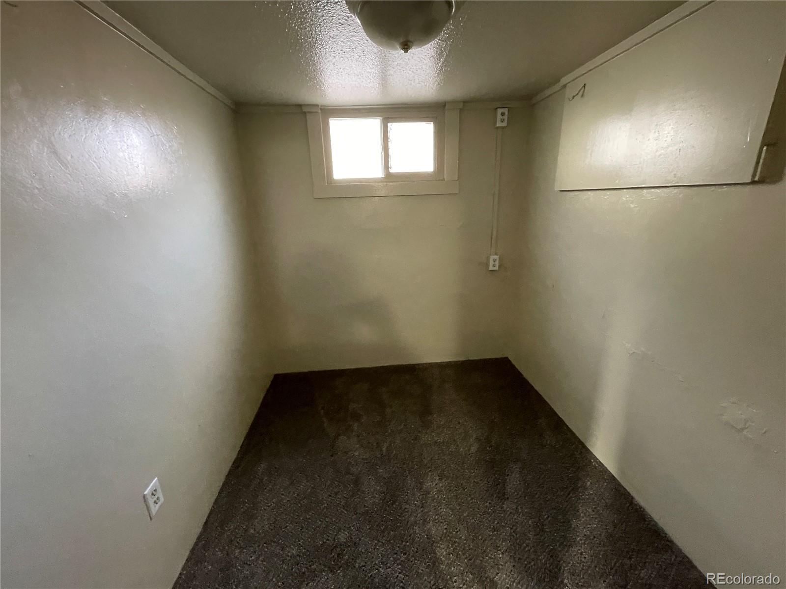 4941 Sherman Street, Unit B Denver, CO 80216 - Photo 12 of 14 an empty room with a hallway