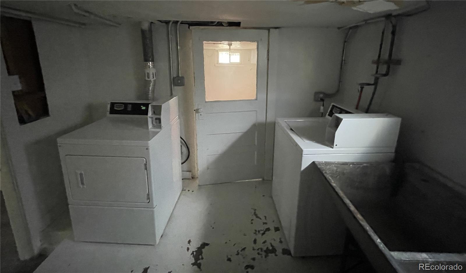 4941 Sherman Street, Unit B Denver, CO 80216 - Photo 14 of 14 a bathroom with a sink and mirror