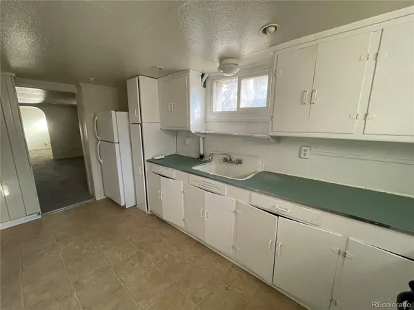a kitchen with stainless steel appliances granite countertop a refrigerator sink and cabinets