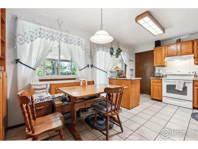 a dining room with furniture a chandelier and a rug