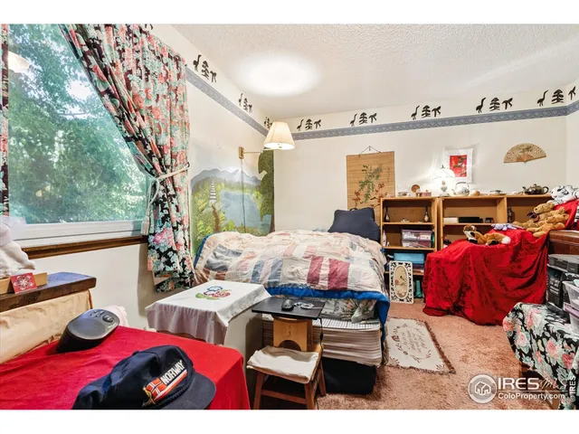 a bedroom with furniture and a large window
