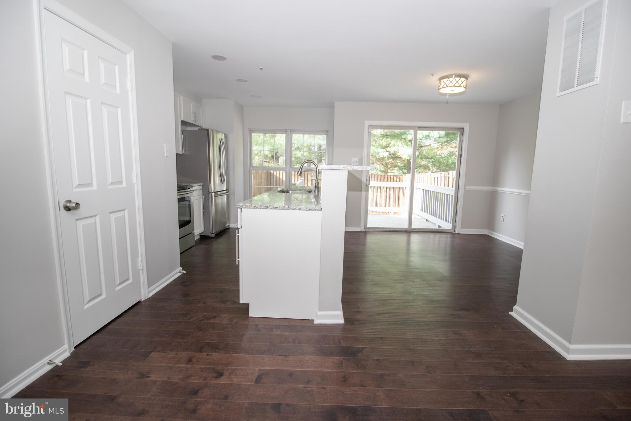 7708 Scatteree Road Severn, MD 21144 - Photo 11 of 41 a view of a room with wooden floor and a window