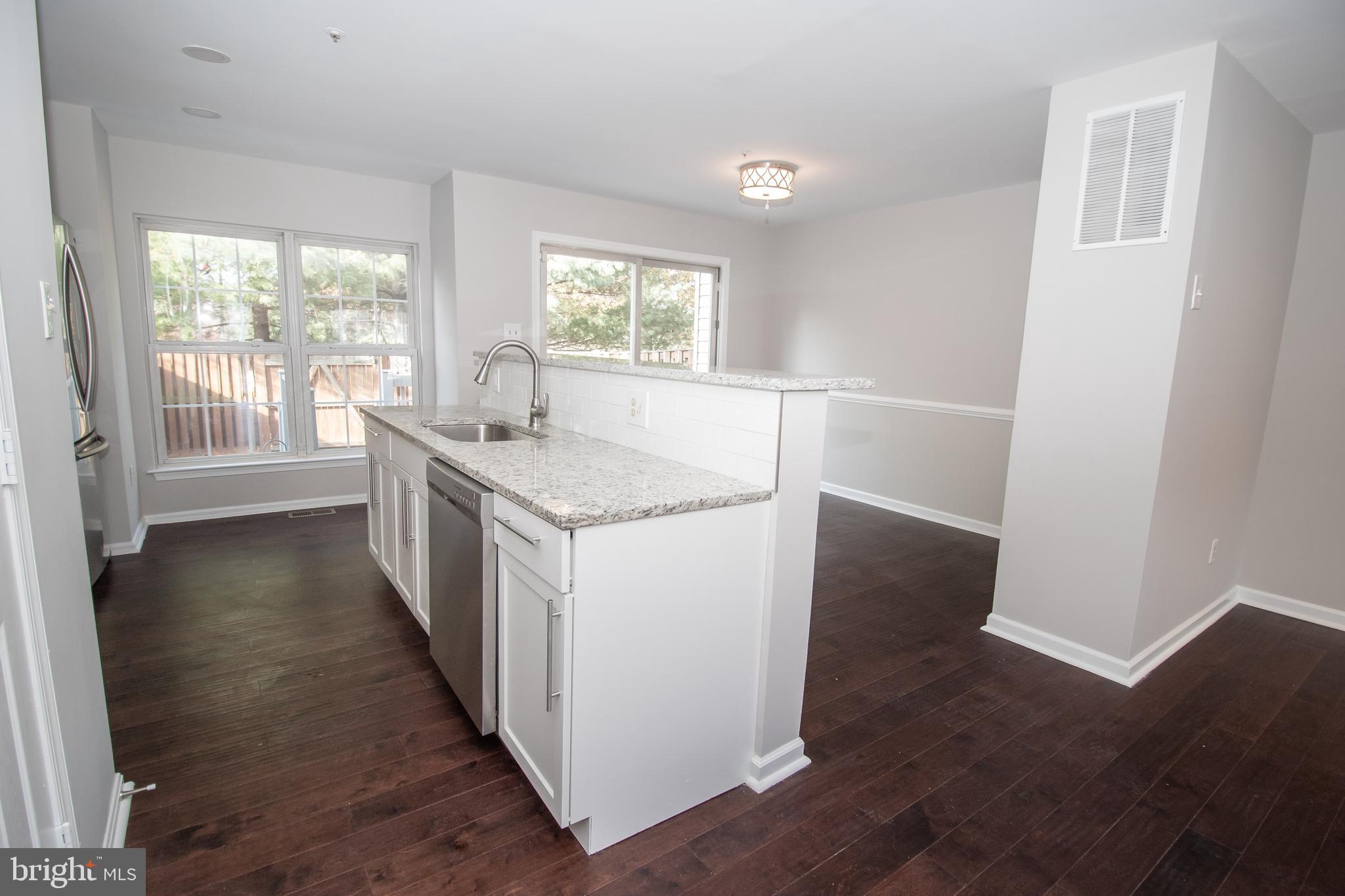 7708 Scatteree Road Severn, MD 21144 - Photo 12 of 41 wooden floor in an empty room with a window