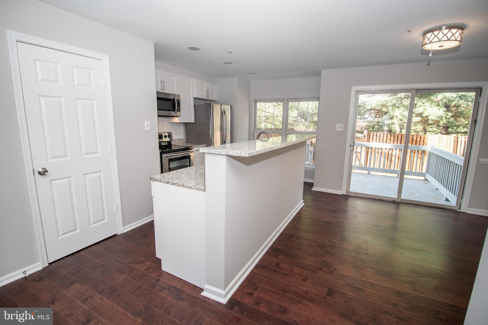 7708 Scatteree Road Severn, MD 21144 - Photo 13 of 41 a view of a kitchen with a sink dishwasher and a refrigerator