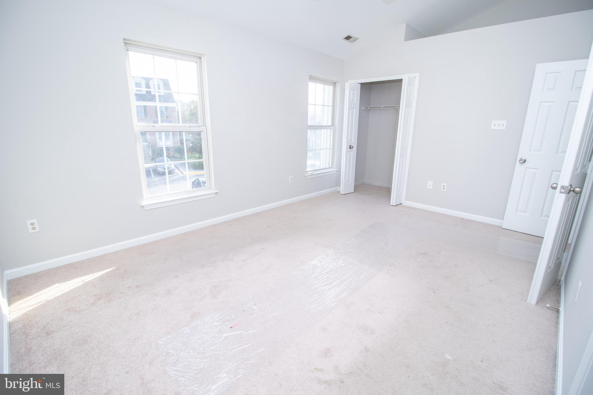 7708 Scatteree Road Severn, MD 21144 - Photo 22 of 41 an empty room with windows and closet