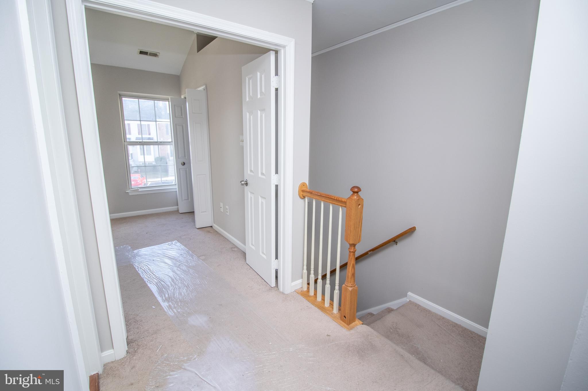 7708 Scatteree Road Severn, MD 21144 - Photo 27 of 41 a view of a hallway with wooden floor and entryway