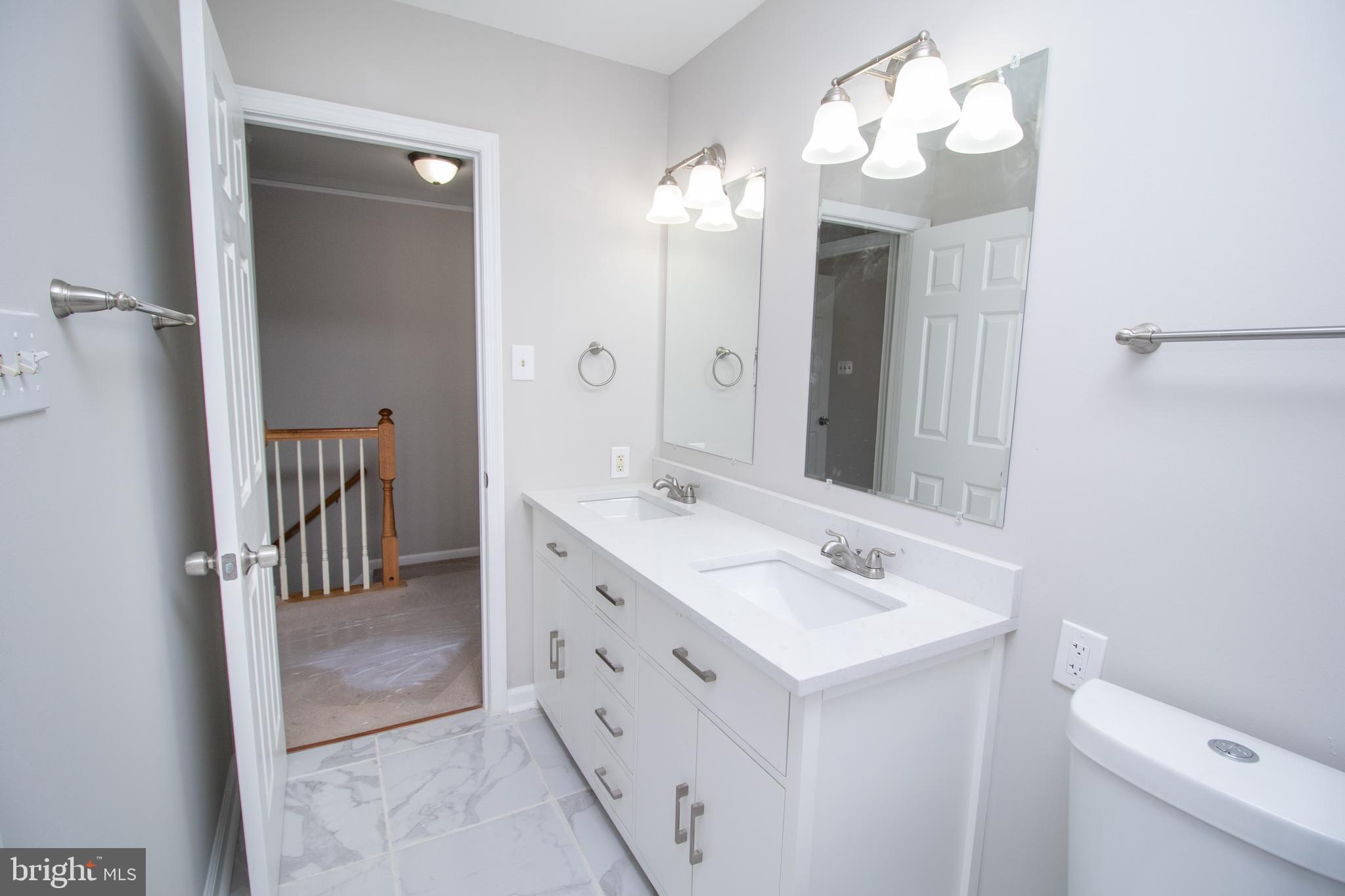 7708 Scatteree Road Severn, MD 21144 - Photo 31 of 41 a bathroom with a sink vanity and a mirror