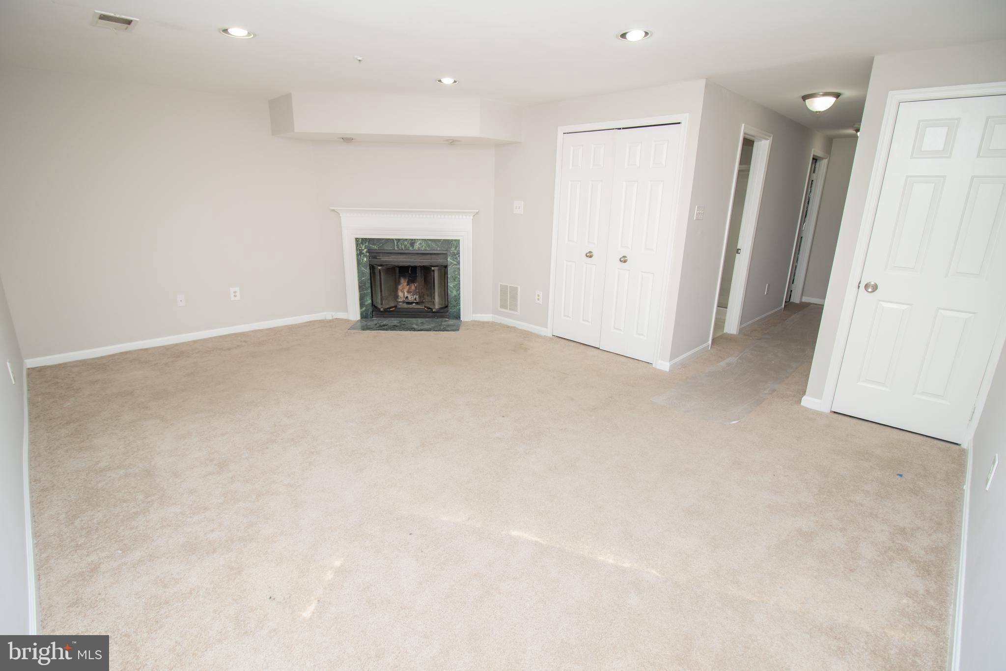 7708 Scatteree Road Severn, MD 21144 - Photo 35 of 41 an empty room with fireplace
