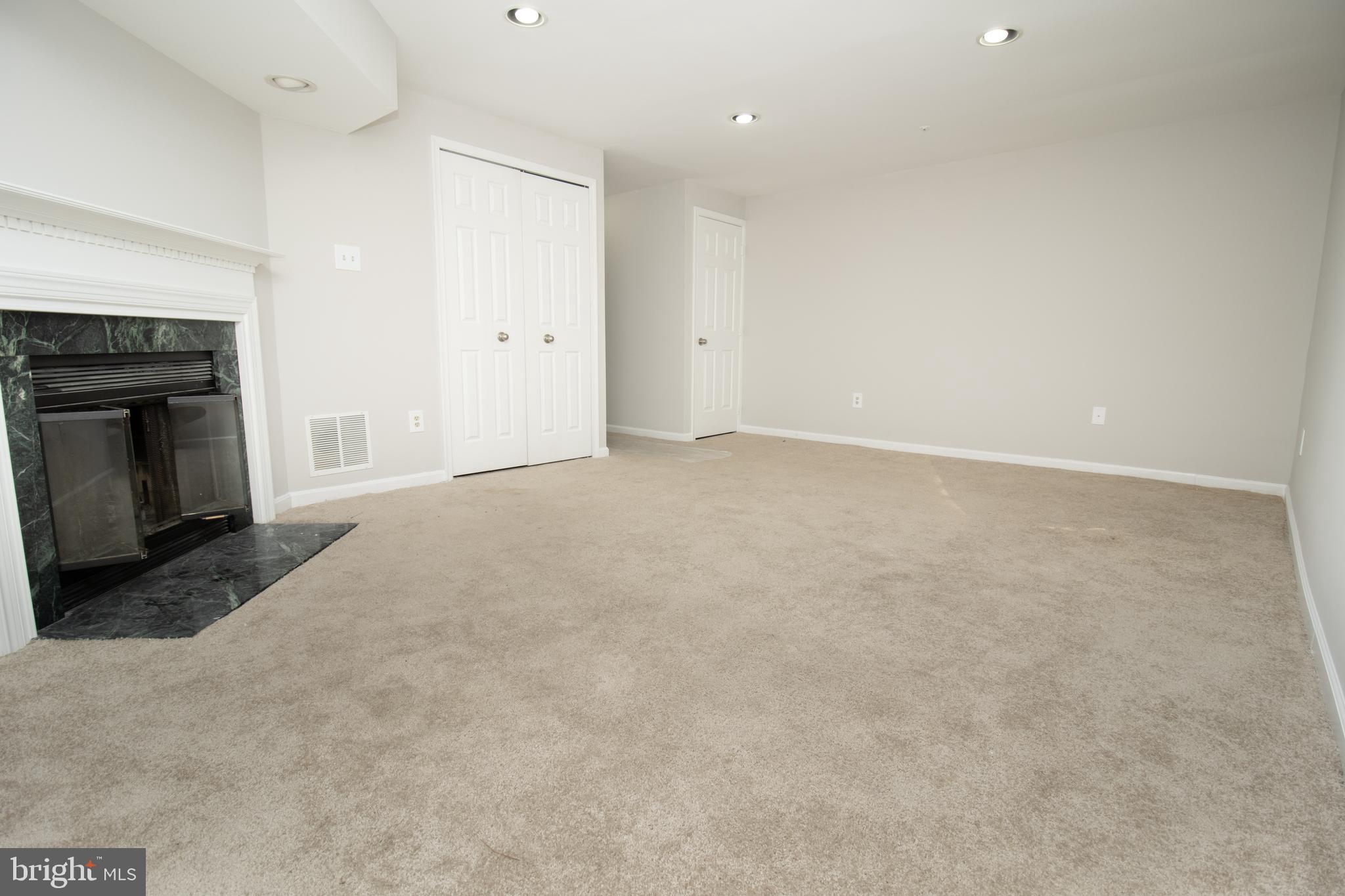 7708 Scatteree Road Severn, MD 21144 - Photo 36 of 41 a view of an empty room with a fireplace