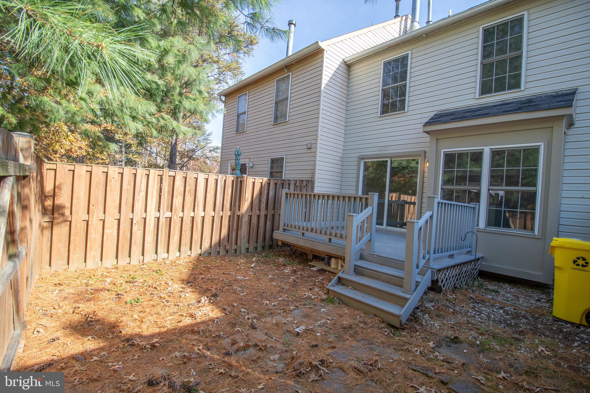 7708 Scatteree Road Severn, MD 21144 - Photo 38 of 41 a view of a house with backyard and wooden fence