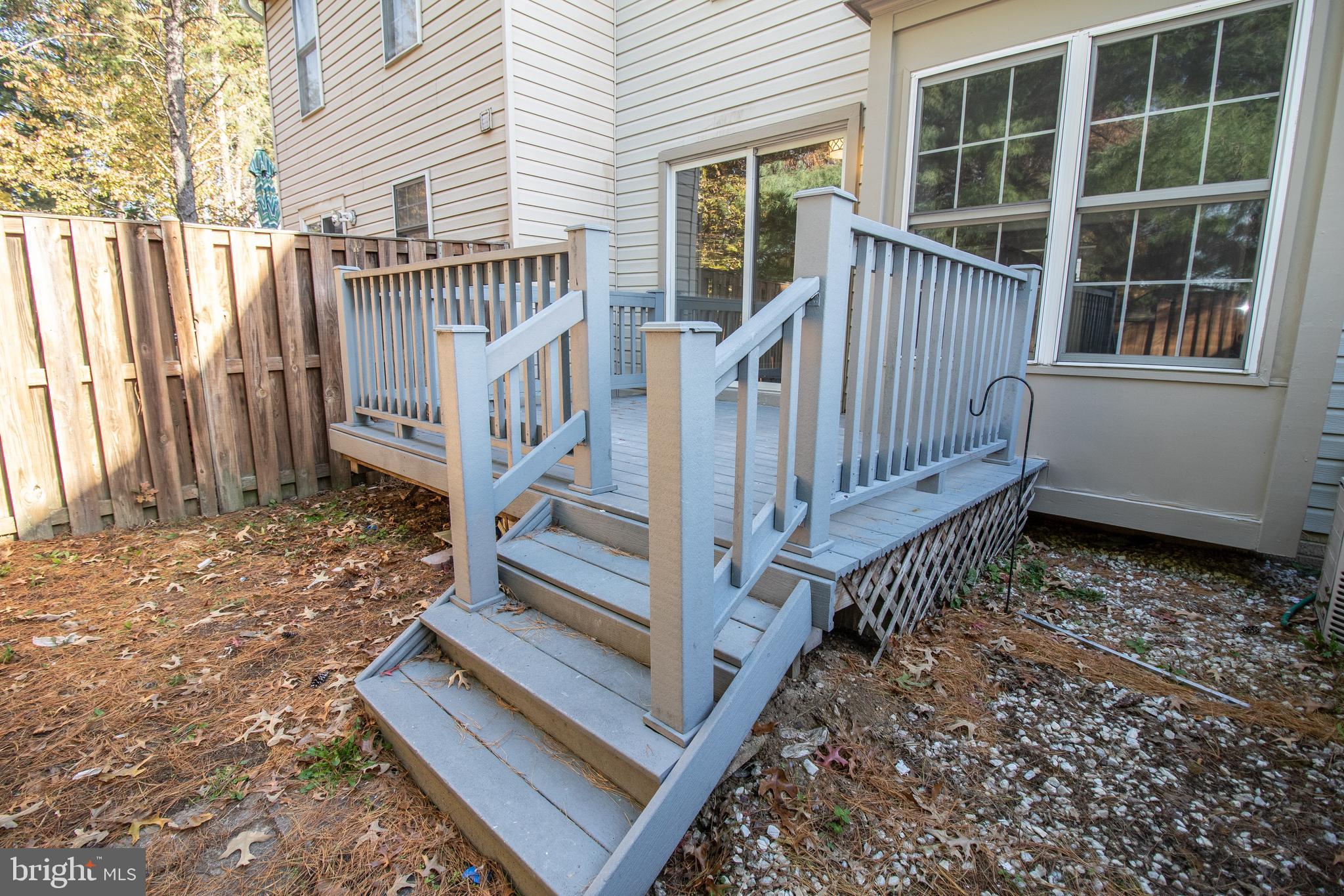 7708 Scatteree Road Severn, MD 21144 - Photo 39 of 41 a view of a house with wooden floor and a small yard