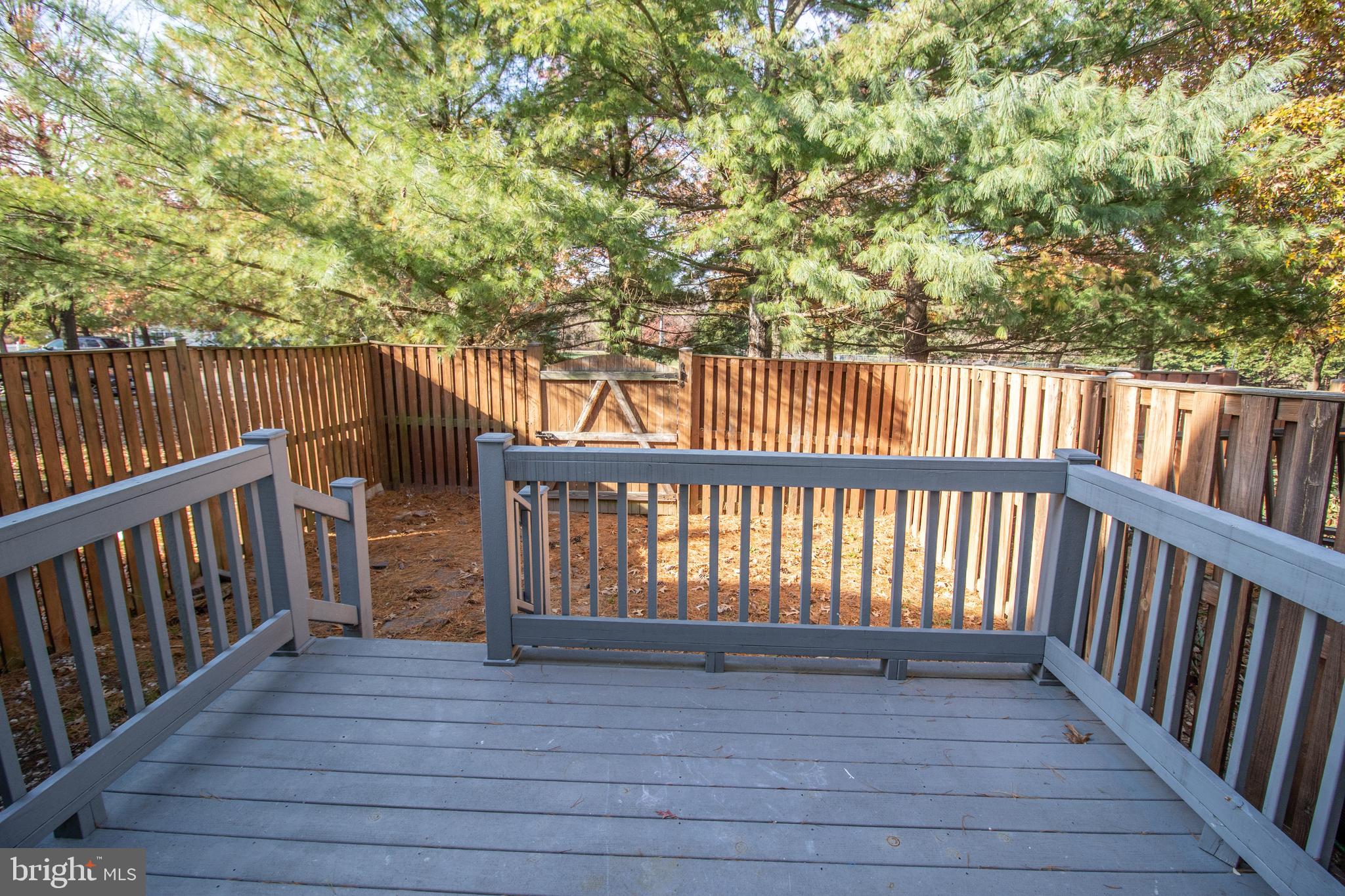 7708 Scatteree Road Severn, MD 21144 - Photo 41 of 41 a balcony with wooden floor and fence