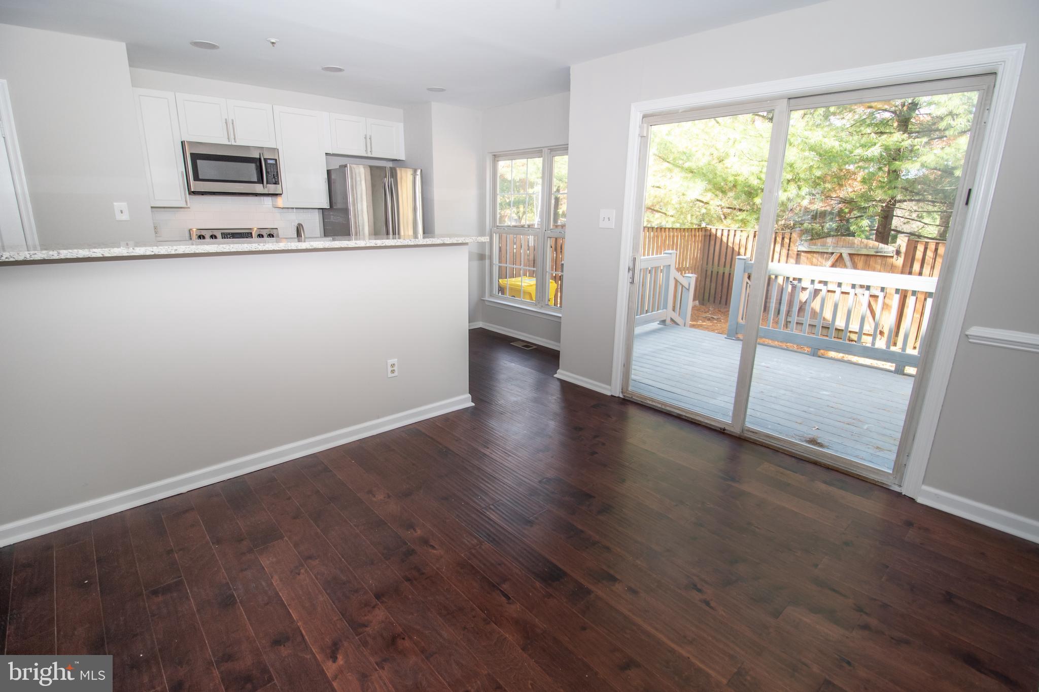 7708 Scatteree Road Severn, MD 21144 - Photo 8 of 41 a view of a living room with hardwood floor and a large window